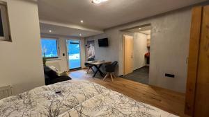 a bedroom with a bed and a desk in a room at Tauernchalet-S'Hoamatl in Hollersbach im Pinzgau