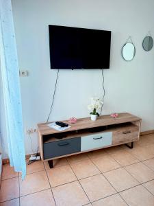 a living room with a tv on a wall at Le Petit Oasis à Saint-Denis in Saint-Denis +5 photos