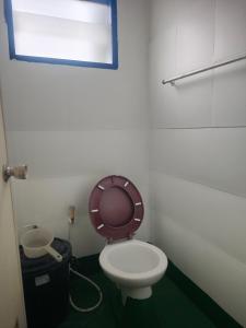 a bathroom with a toilet with the lid up at Worsakornrit Homestay in Bangkok