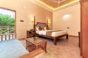 a hotel room with a bed and a window at The Bagh Villa Pench By Ficusroots Experience in Khawāsa