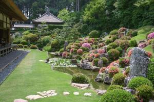 a garden with flowers and a stream of water at キュリナリーBed and Art in Hamamatsu