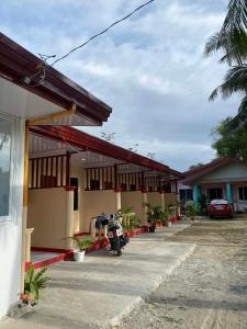 a building with a motorcycle parked in front of it at JEHH8 Guest House in Siquijor