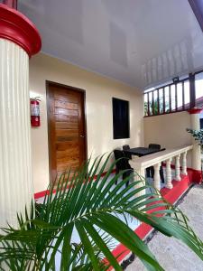 a room with a column and a table and a plant at JEHH8 Guest House in Siquijor
