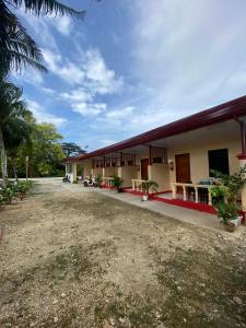 a group of buildings with a dirt yard at JEHH8 Guest House in Siquijor +6 photos