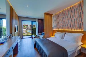 a bedroom with a bed and a desk and a kitchen at Celeste Bella Luxury Hotel & Spa in Bodrum City +54 photos