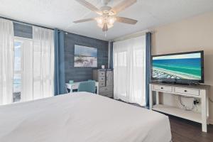 a bedroom with a bed and a flat screen tv at Emerald Isle 708 in Fort Walton Beach