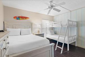a bedroom with a bed and a bunk bed at Emerald Isle 708 in Fort Walton Beach +46 photos