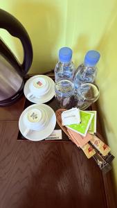 a table with plates and bottles of water on it at Angkor Sandra Villa in Siem Reap