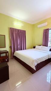 a bedroom with a large bed with purple curtains at Angkor Sandra Villa in Siem Reap