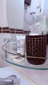 a glass table with a basket of toiletries on it at Angkor Sandra Villa in Siem Reap +27 photos