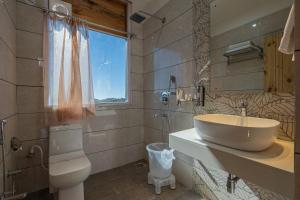a bathroom with a sink and a toilet at The Golden Castle Hotels in Mukteshwar +58 photos
