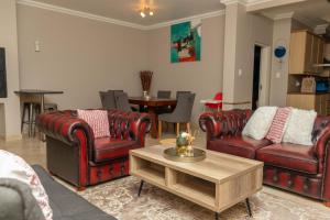 a living room with leather furniture and a table at Don Self Catering in Walvis Bay