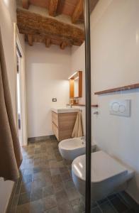 a bathroom with a toilet and a sink at B&B Le Grazie in Parma
