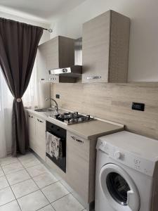 a kitchen with a washing machine and a washer at Agriturismo San Giuliano dei fratelli Giai in Susa