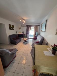 a living room with couches and a table at Ariadni's Dreamhouse in Akrata