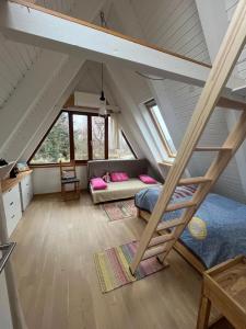a bedroom with a bunk bed and a ladder at NurdachZeit – Ferienhaus in Schellbronn in Neuhausen