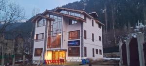 a large white building with a lot of windows at Hotel Pahalgam view in Pahalgām +11 photos