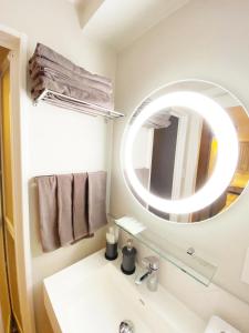a bathroom with a sink and a mirror at precious days inn in Fukuoka