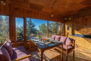 a wooden dining room with a table and chairs at The Golden Castle Hotels in Mukteshwar