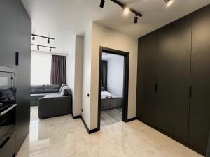a living room with a couch and a bedroom at Апартаменти Парус Сіті in Lviv