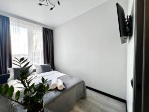 a bedroom with a bed and a tv on a wall at Апартаменти Парус Сіті in Lviv