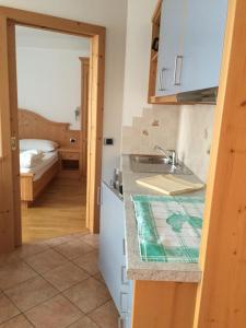 a kitchen with a sink and a counter top at Garni Cristallo in San Vigilio Di Marebbe +26 photos
