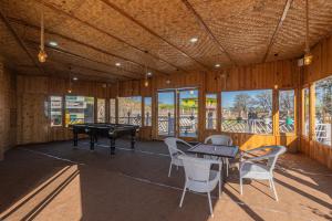 a large room with a pool table and chairs at The Golden Castle Hotels in Mukteshwar