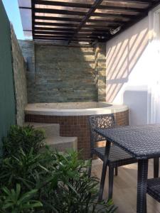 a patio with a table and a bench and stairs at Boracay Haven Suites in Boracay