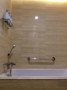 a bathroom with a bath tub with a faucet at Boracay Haven Suites in Boracay