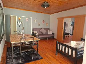 a living room with a table and a couch at The V8 House in Sutherland