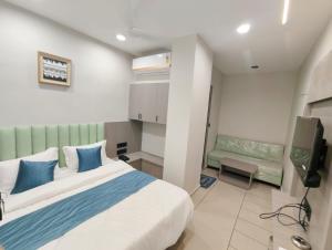 a bedroom with a bed and a tv in it at Hotel Signature Bopal in Ahmedabad +14 photos