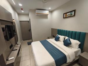 a bedroom with a bed and a television in it at Hotel Signature Bopal in Ahmedabad