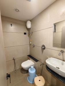 a bathroom with a toilet and a sink at Hotel Signature Bopal in Ahmedabad