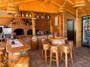 a bar with wooden stools and a counter in a room at Casa Alexia in Potoc