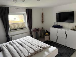 a bedroom with a white bed and a window at Apartment in der Au in Langkampfen