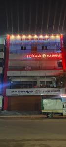 a bus parked in front of a building at night at Rk comforts & lodge in Madhugiri