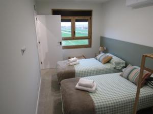 a room with two beds with towels on them at La Alcoholera in Valtierra +26 photos