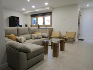 a living room with a couch and a table at La Alcoholera in Valtierra
