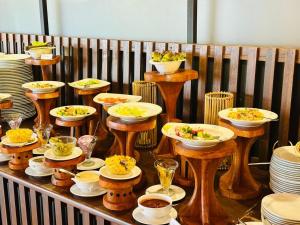 a table filled with plates and bowls of food at Bluefield Cabana in Ramboda +7 photos