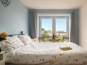 a bedroom with a bed with a book on it at Harbour View in Cemaes Bay +14 photos