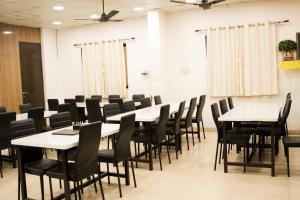 a conference room with tables and chairs at Stay Prime, Balewadi in Pune