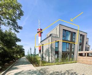 a building with an antenna on top of it at Penthouse Seeblick am Leuchtturm in Fehmarn