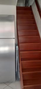a staircase with a stainless steel refrigerator in a room at Maisonnette n 43" La Tortue " in Frontignan