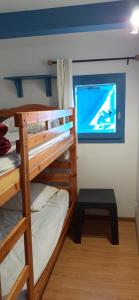 a bunk bed room with two bunk beds and a window at Maisonnette n 43" La Tortue " in Frontignan