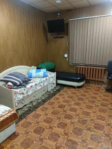 a room with two beds and a flat screen tv at Хостел AUTOMAX in Dnipro