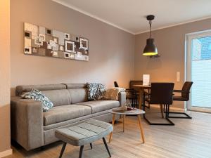 a living room with a couch and a table at Ankertau in Norden