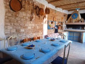 a table with blue plates on it in a room at Casa Pili in San Vito