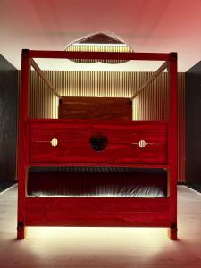 a red dresser in a room with at Luxury Jacuzzi Suites Halifax in Halifax