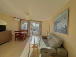a living room with a couch and a table at Terrasol Pirámides Puerto Blanco in Caleta De Velez
