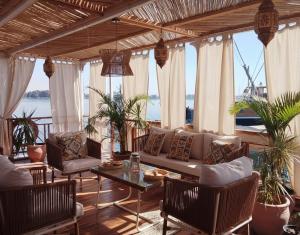 a living room with a couch and chairs and a table at Amber Dahabiya in Luxor